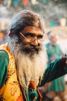 A vibrant and expressive portrait of an elderly man with a full beard in traditional attire, captured outdoors.